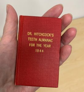 Go to fulll image of tiny red book that fits in a hand
