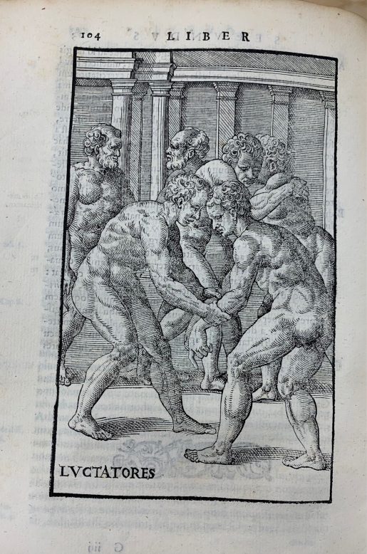 A page of a book featuring an engraving-style illustration of several nude men, posed as if wrestling.